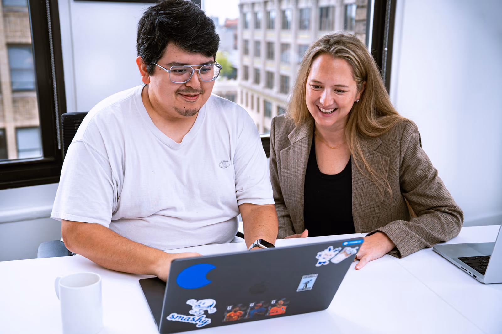 GovDash teammates collaborating at a laptop