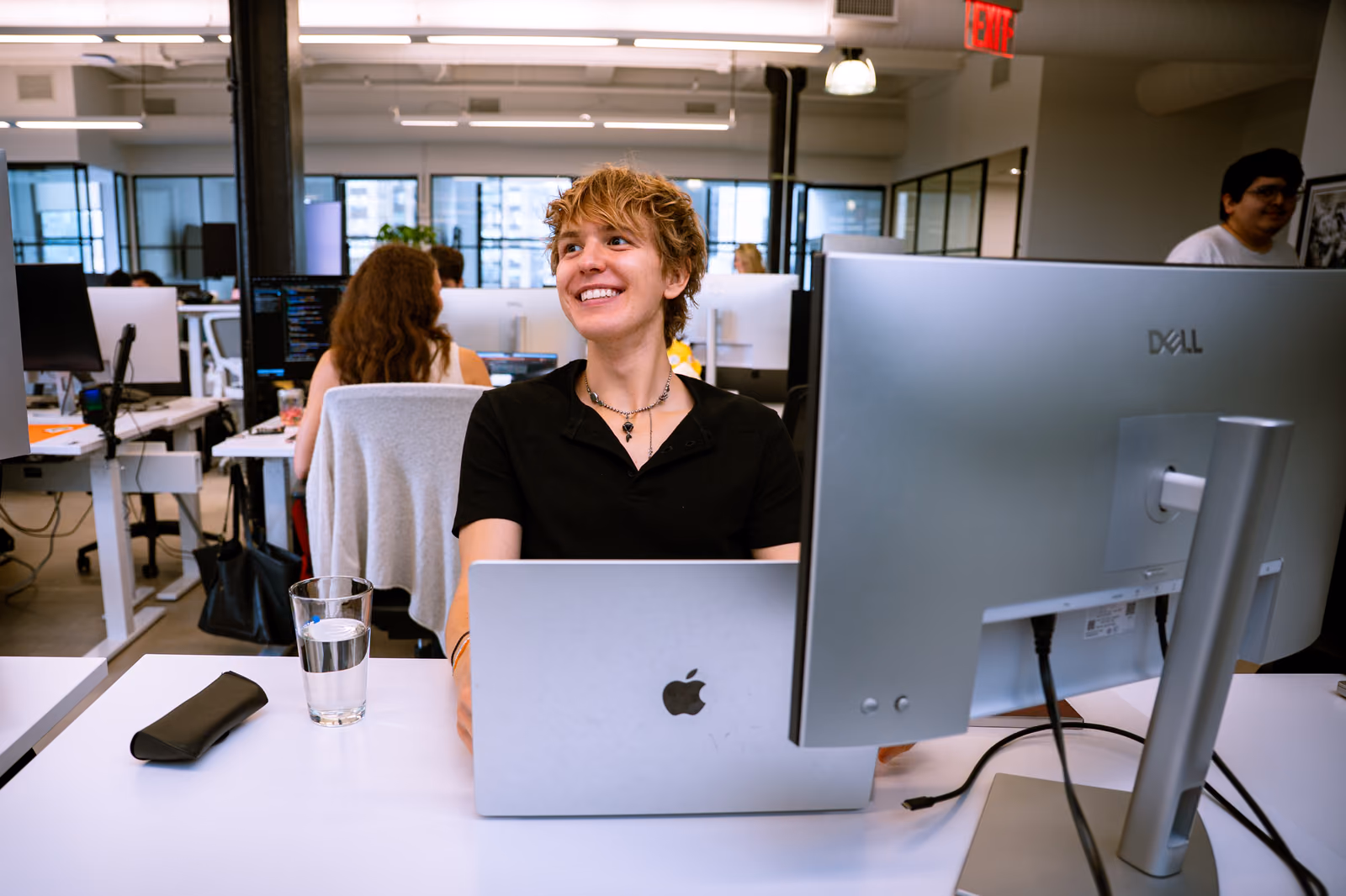 GovDash team member smiling at their desk